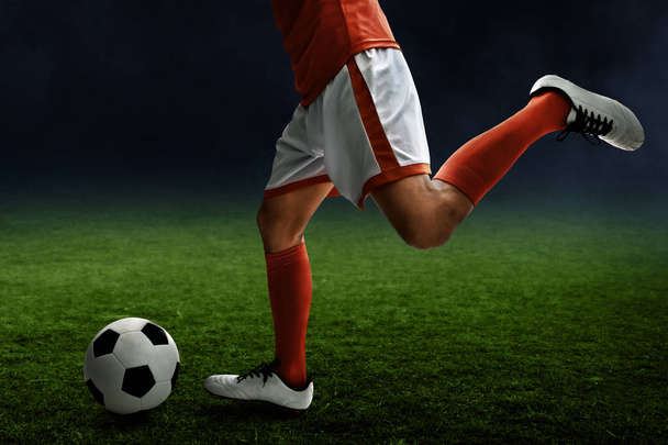 Soccer player kicking ball - Fotó, kép