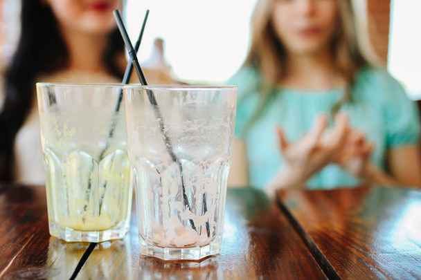 Two empty glasses stand on a table in a cafe. - Foto, imagen