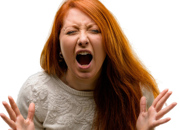 Beautiful young redhead woman stressful, terrified in panic, shouting exasperated and frustrated. Unpleasant gesture. Annoying work drives me crazy isolated over white background - Photo, Image