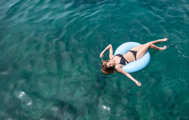 Girl relax on the sea. Beautiful girl as a concept and idea of relax time - Photo, Image