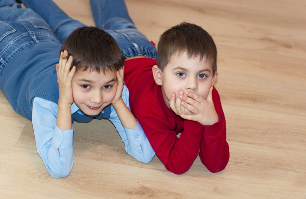 two boy, the brother lies on a floor - Valokuva, kuva