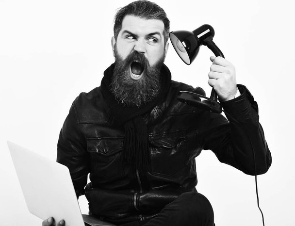 Bearded brutal caucasian hipster sitting with laptop - Photo, image