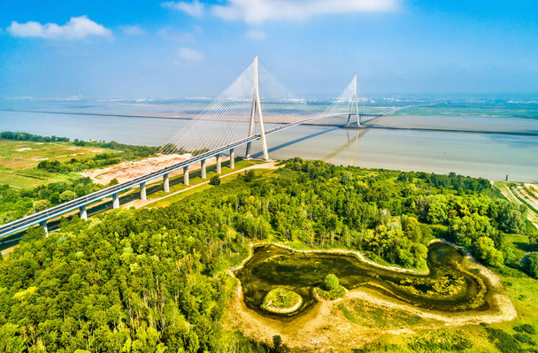 Aerial view of the Pont de Normandie, a cable-stayed road bridge that spans the river Seine linking Le Havre to Honfleur in Normandy, northern France - Photo, Image