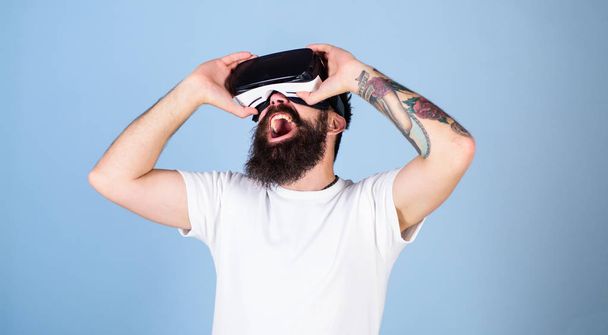 Man in VR glasses screaming. Bearded gamer playing games with VR headset. Hipster with trendy beard having frightening cyber experience. Bearded man watching 360 video, virtual reality concept - Foto, imagen