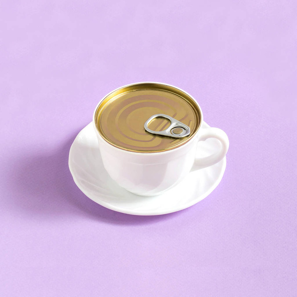 Cup of coffee like tincan on pastel purple background. Minimal style. Creative idea, imagination and fantasy. Original food concept: food and storage - Photo, Image