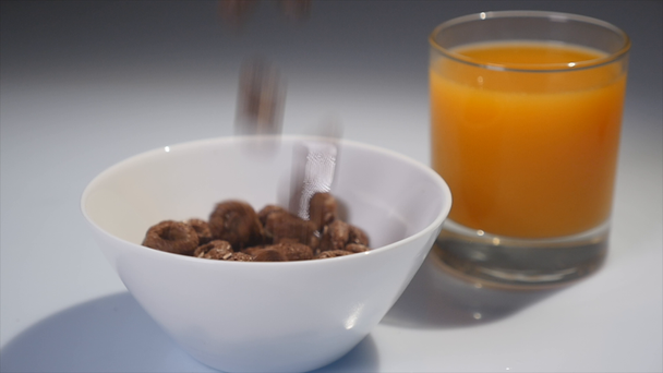 Close-up of chocolate flakes are falling in a glass dish. Chocolate balls falling in a glass bowl - Footage, Video