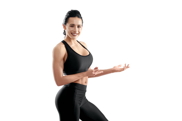 Sideview of smiling athletic model posing on white studio background. - Φωτογραφία, εικόνα