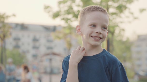 Portret of beautiful smiling boy in the park. Sun and nice nature. Slow motion - Footage, Video