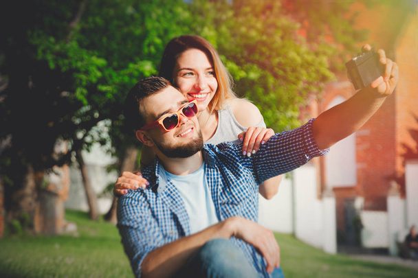 Young white couple have a fun with vintage camera - Photo, image
