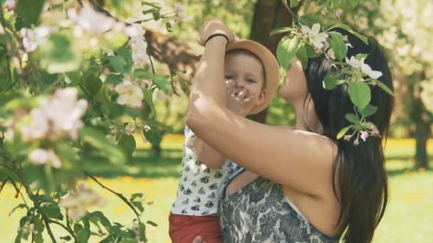 Young mother with her adorable little boy playing outdoors with love - Footage, Video