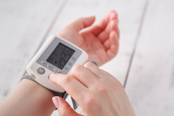 Senior woman measuring blood pressure. Health care background - Фото, изображение