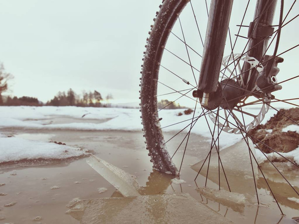 MTB bicycle resting in muddy puddle. Adventure and extreme cycling concept, self motivation and inspiration. - Photo, image