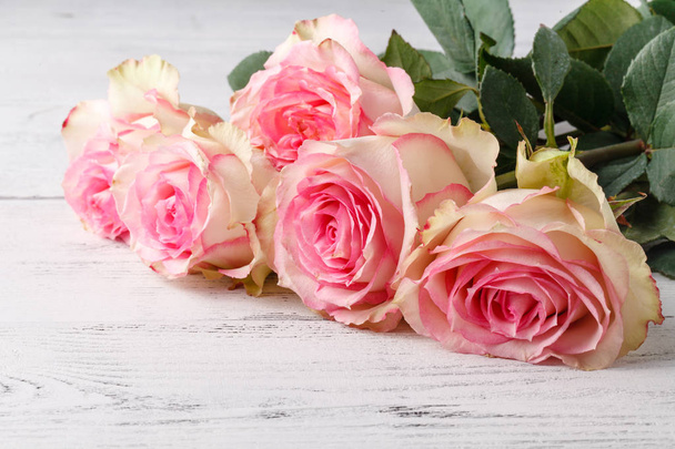 Bouquet of pink roses on old wooden board background, vintage toning - Foto, immagini