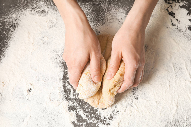Young woman kneading dough for pasta on table, top view - Фото, зображення