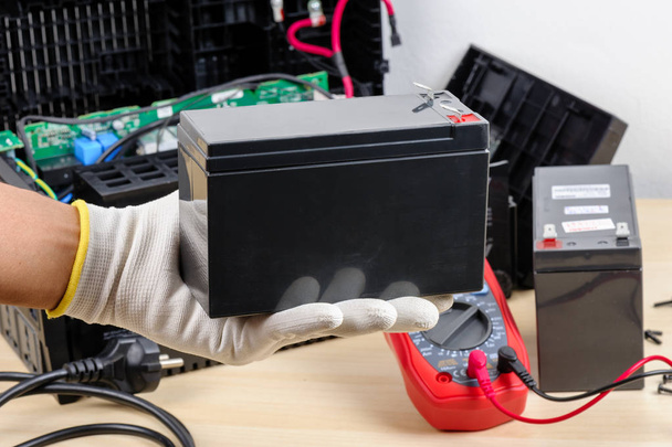 Technician replacing the UPS(Uninterruptible Power Supply) battery. - Photo, Image