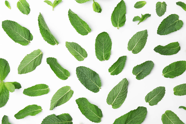 Flat lay composition with fresh green mint leaves on white background - Фото, зображення