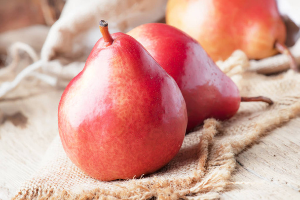 Ripe red pears on rustic wooden background, selective focus - Fotoğraf, Görsel