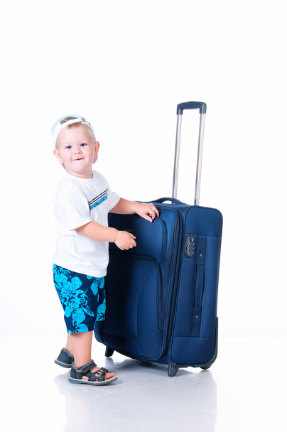 Small tourist with suitcase on white background - Foto, Bild
