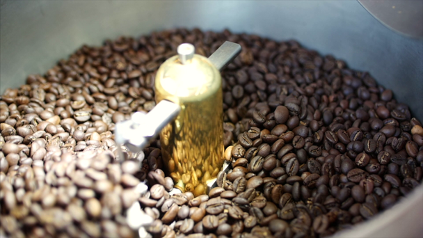 Mixing of roasted coffee. Partial removal of bad grains. The roasted coffee beans got on the mixer sorting by a professional machine. Slow motion. - Video