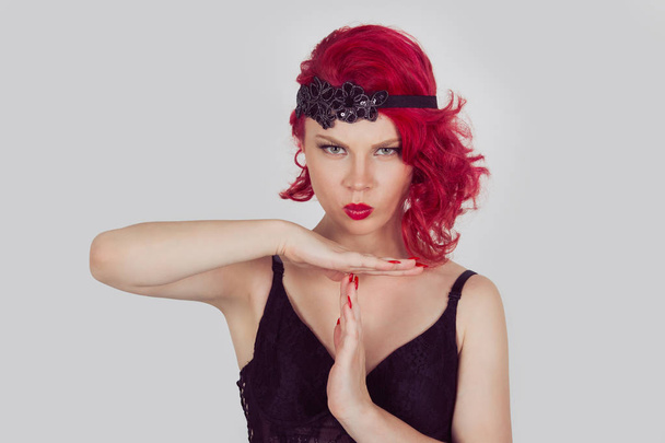 Woman serious girl showing time out pause with arms hands gesture. Red head curly bob hairstyle girl isolated light gray grey white background. Mixed race latin hispanic caucasian fashion model - 写真・画像