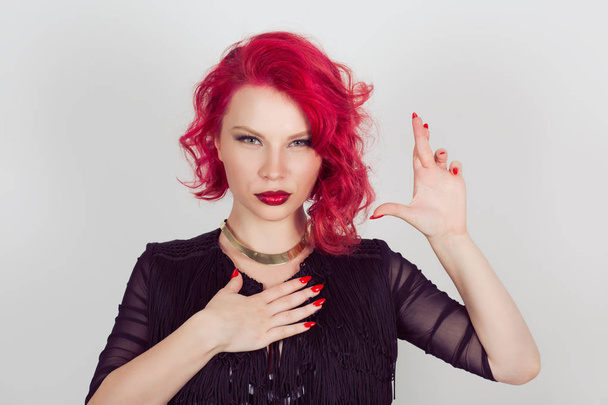 A liar. Woman sly witness making a false promise or testifies falsely hands gesture. Red head curly bob hairstyle girl isolated light gray white background. Mixed race hispanic caucasian fashion model - Фото, зображення