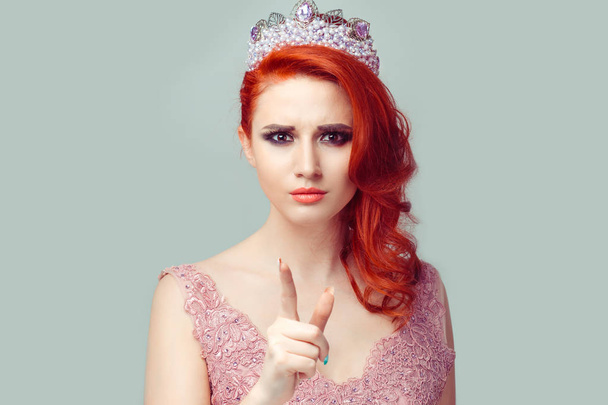 It's you! Portrait angry unhappy annoyed young woman getting mad pointing finger at you camera showing hand gesture this is you, pretty woman with pearls crown on head isolated light green background. - Фото, изображение
