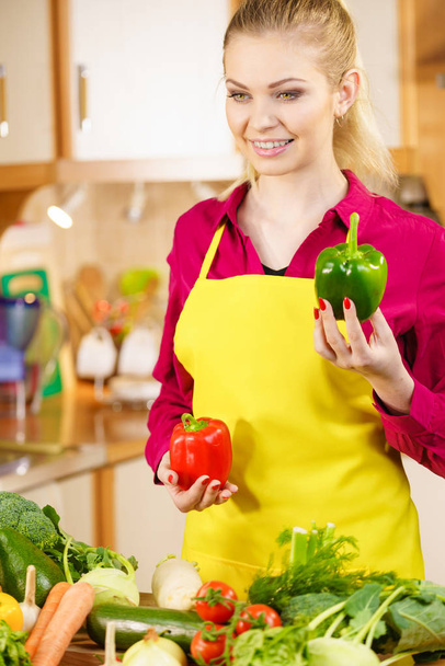 Funny joyful woman holding bell pepper delicious healthy dieting vegetable presenting diet food. - 写真・画像