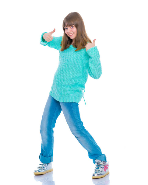 Girl teenager holds a thumb up - Foto, Imagen
