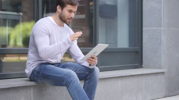 Online Video Chat on Tablet by Handsome Man Sitting Outside Office - Footage, Video