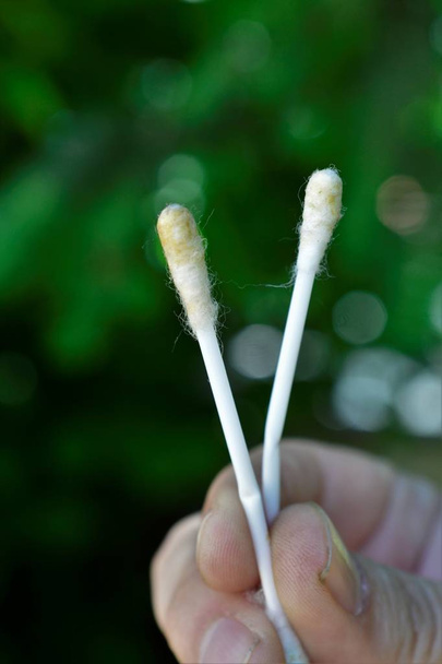 fingers holding two cotton stick with ear wax,image - Photo, Image