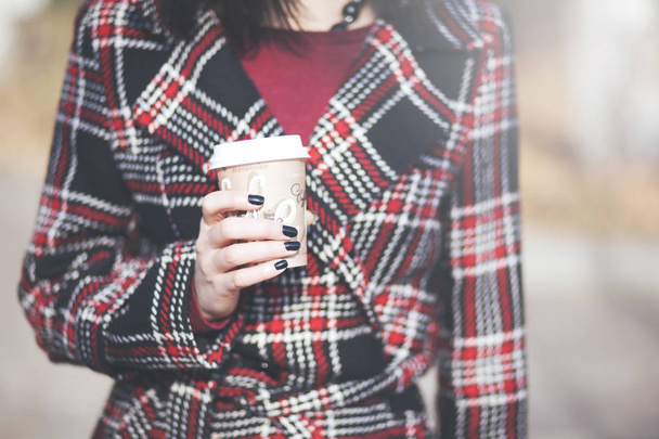 Fashion woman with cup of coffee on street at autumn - Zdjęcie, obraz
