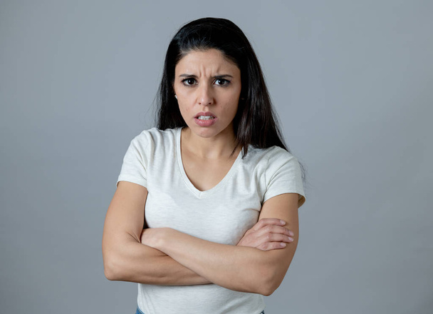 Close up portrait of an attractive young latin woman with an angry face. looking furious and moody with an intense look showing anger and rage. Human facial expressions and emotions - Foto, Imagem