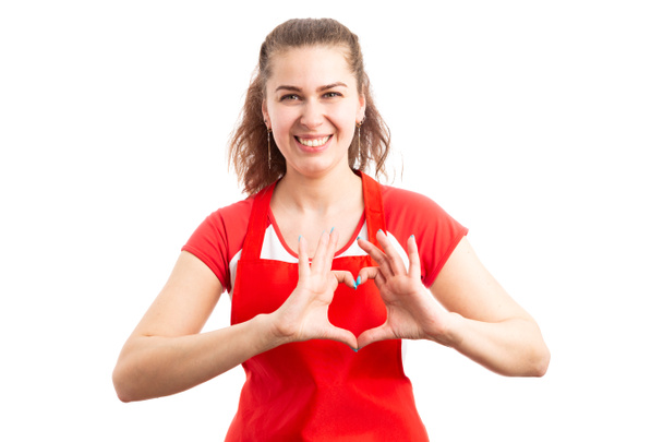 Trabajadora de supermercado o empleada de hipermercado mostrando gesto de amor con las manos como concepto de forma de corazón aislado sobre fondo blanco
 - Foto, imagen