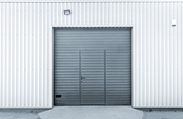 Closed modern steel garage or warehouse doors, colorized industrial picture - Photo, Image