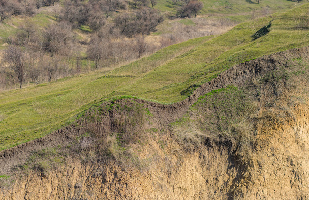 Slope of the hill in section in early spring season in Ukraine - Photo, Image