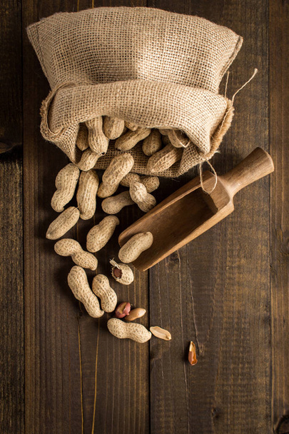 Organic Peanuts in Shells on Rustic Wooden Background with Copy  - Valokuva, kuva