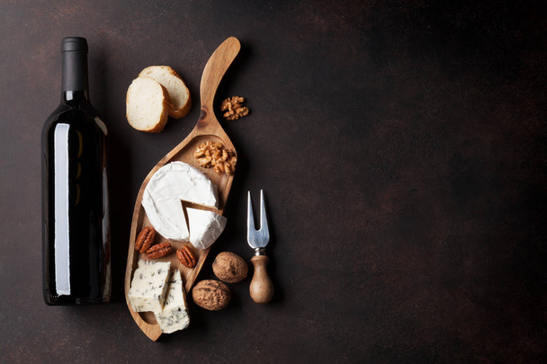 Wine, cheese and nuts on dark background. Top view with copy space - Фото, зображення