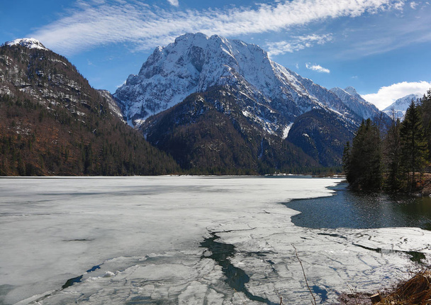 ice on the little alpine lake called Lago Predil in northern Italy near austrian border - Photo, image