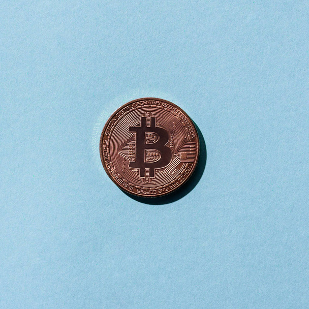 top view of bronze bitcoin on blue background - Φωτογραφία, εικόνα