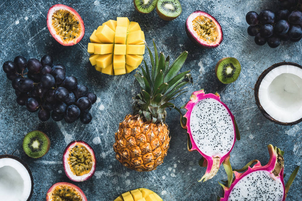 Tropical fruits, exotic fruits on concrete background. Flat lay - Foto, Imagem