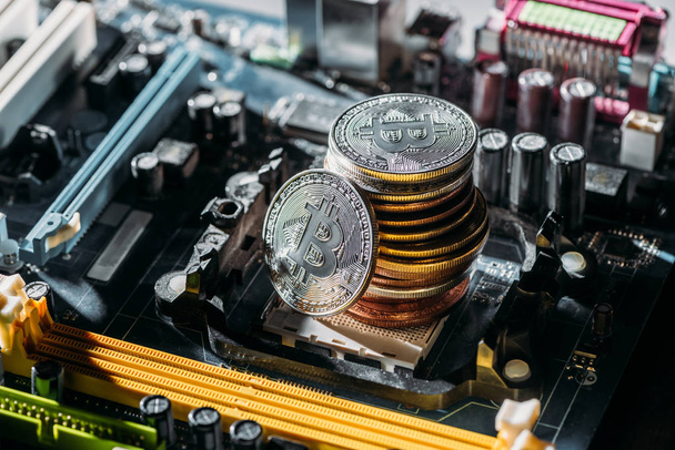 close up view of pile of bitcoins on computer motherboard - Фото, зображення