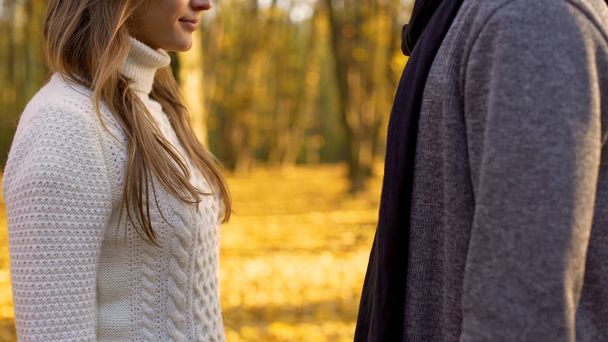 Man and woman dating in autumn forest, falling in love, romantic atmosphere - Photo, Image