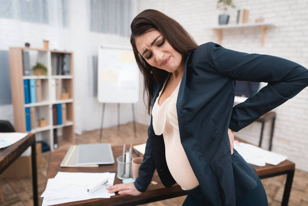 pregnant woman experiencing labor in office - Photo, image