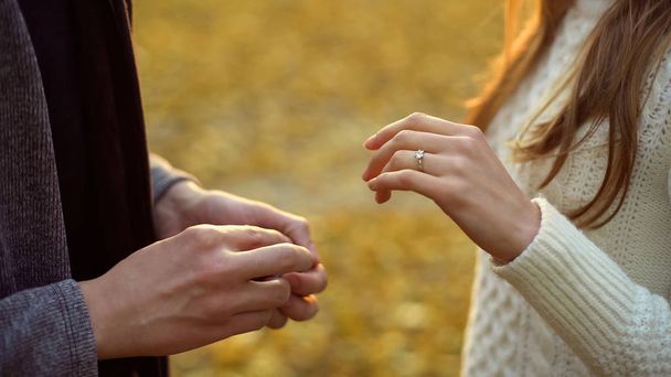 Girl with wedding ring, boyfriend proposing in autumn woods, romance, closeup - Foto, immagini
