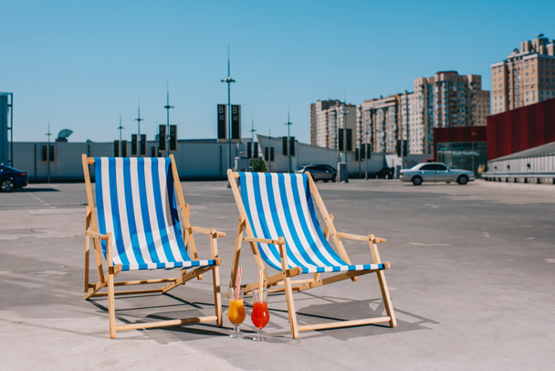 sun loungers with cocktail on parking on sunny day - 写真・画像