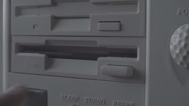 Close-up of inserting and removing an old-style 5.25" floppy disk. - Felvétel, videó