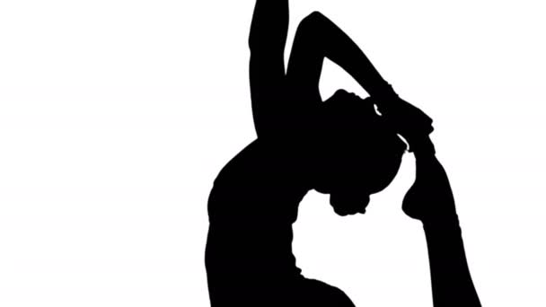 Woman doing stretching exercises, practicing yoga track matte - Кадри, відео