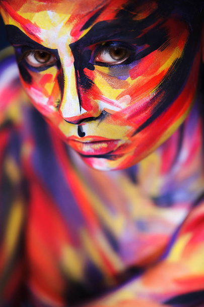Portrait of the bright beautiful girl with painting art colorful make-up on face and bodyart. Creative vertical ads banner or flyer with copy space. - Foto, Imagen