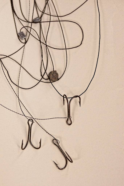 Set of hooks and fishing line on a gray surface - Foto, Imagen