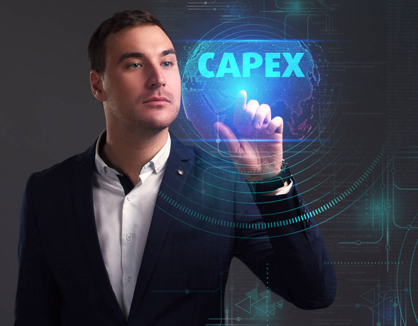 Business, Technology, Internet and network concept. Young businessman working on a virtual screen of the future and sees the inscription: Capex - Valokuva, kuva